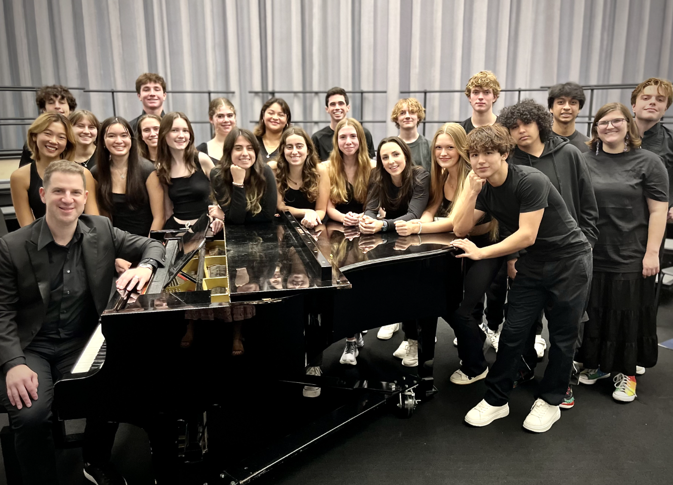 Bill and students around a piano